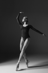 Young beautiful modern style dancer posing on a studio