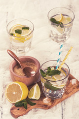Fototapeta na wymiar Fresh homemade lemon and lime lemonade served with mint, ice cubes. Toned image