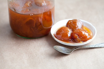 apricot jam in a glass jar and plate