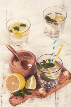 Fresh homemade lemon and lime lemonade served with mint, ice cubes. Toned image