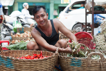 Asian man street market seller bunch green onion