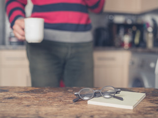 Book and glasses on table in kitchen