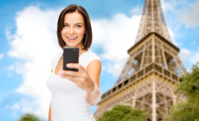 woman taking selfie with smartphone in paris