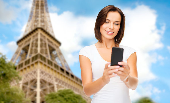 woman with smartphone over eiffel tower