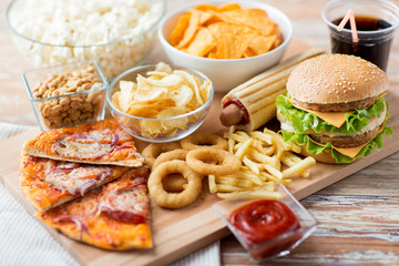 Fototapeta close up of fast food snacks and drink on table obraz