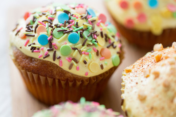 close up of glazed cupcakes or muffins on table