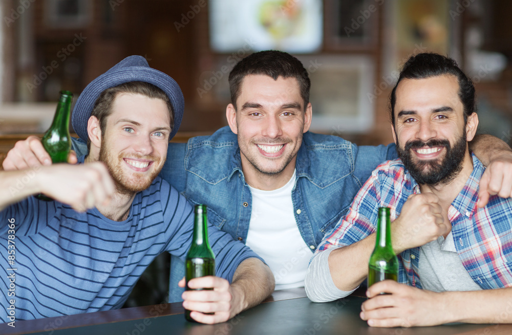 Sticker happy male friends drinking beer at bar or pub