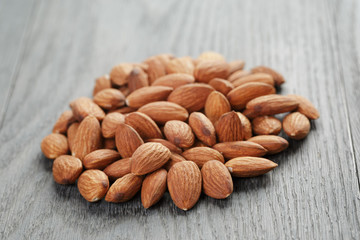 roasted almonds on gray wooden table