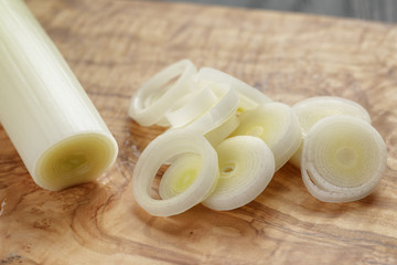 sliced fresh leek on olive board