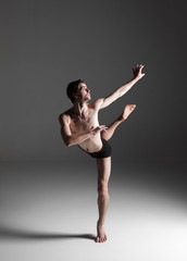 The young attractive modern ballet dancer on white background