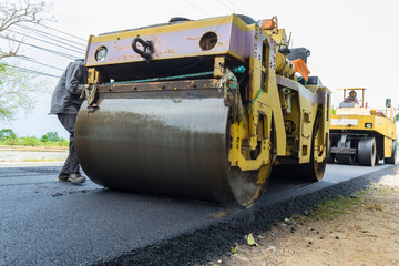 Heavy Vibration roller compactor at asphalt pavement works for road repairing