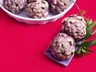 Purple artichokes on vivid background with copy space