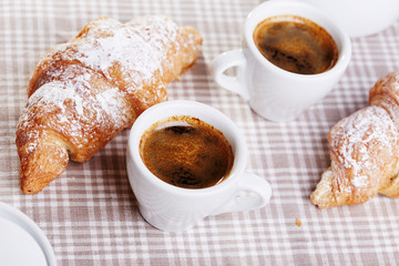 Cups of coffee with croissant