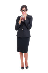 Full body of business woman drinking healthy juice