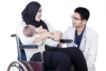 Doctor speaking with muslim mother