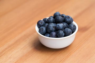 A white bowl full of blueberries