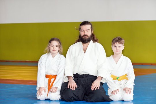 Children sitting on tatami with their Aikido instructor
