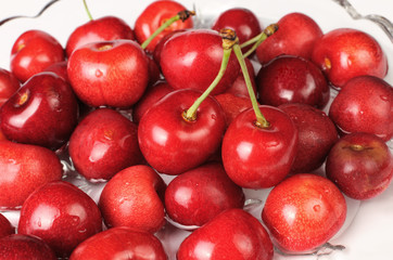 Red cherries in a dish of water