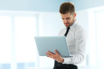 Handsome Businessman Working on Laptop at His Office