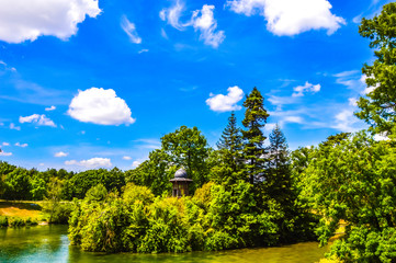 beautiful lake with blue sky and green trees in the forest  - 85398531