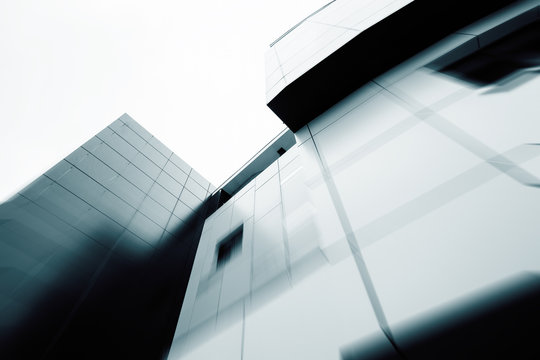 Wide angle abstract background view of steel light blue high rise commercial building skyscraper made of glass exterior. concept of successful industrial architecture and office center building