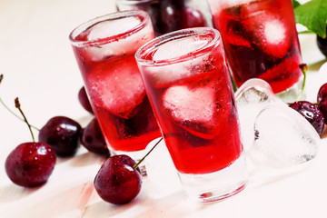 Ice red drink with ice in a heart shape, toned, selective focus