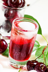 Ice red drink with ice in a heart shape, selective focus