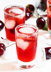 Ice red drink with ice in a heart shape, selective focus