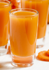 Fresh carrot cocktail glasses, selective focus