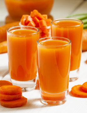 Fresh carrot cocktail glasses, selective focus