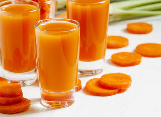 Fresh carrot cocktail glasses, selective focus