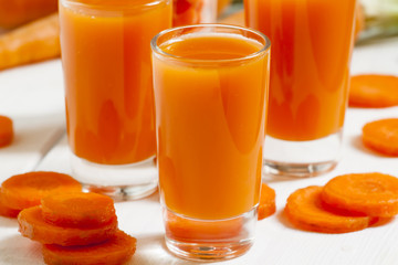 Fresh carrot cocktail glasses, selective focus