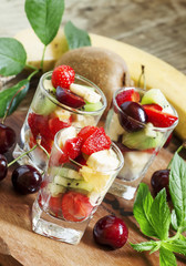 Salad from fruit and berries in glasses, selective focus