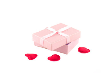Gift box with a pink ribbon and red hearts