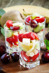 Salad from fruit and berries in glasses, selective focus