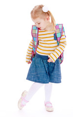 Little blonde girl with a school backpack 