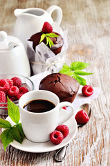 Chocolate muffins with fresh raspberries and a cup of  coffee fo