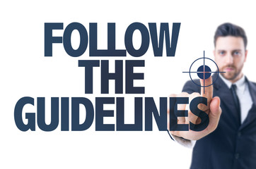 Business man pointing the text: Follow the Guidelines