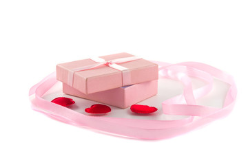 Gift box with a pink ribbon and red hearts and a large pink ribb