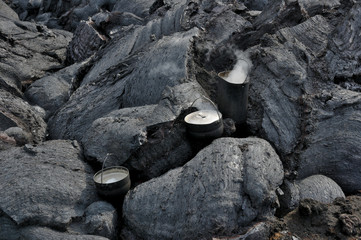 Water boiling in the travel saucepans installed upon the cooling lava stream - 85407396