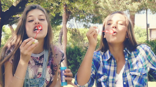 teenager having fun ina park with soap bubbles