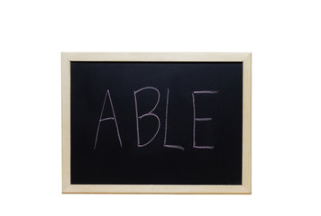 ABLE written with white chalk on blackboard.
