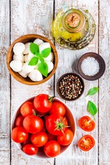 Fototapeta na wymiar mozzarella, cherry tomatoes, salt, pepper, basil and olive oil for caprese salad