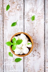 mozzarella in a wooden bowl with basil