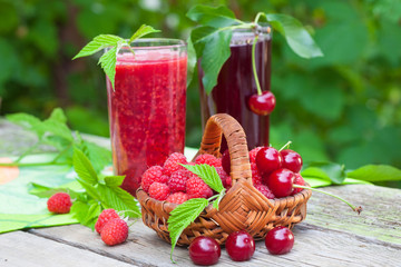 Raspberry and sour cherry smoothies on rustic table