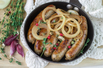 Fried sausages with spices and onions