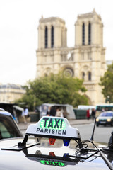 Roof of the free Parisian taxi with the Notre-Dame Cathedral on the background. 