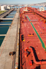 Crude oil tanker ship is moored to a berth in sea port - stock photo.