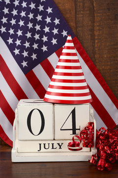 Fourth of July vintage wood calendar with flag background.