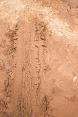 Wheel tracks on the soil.